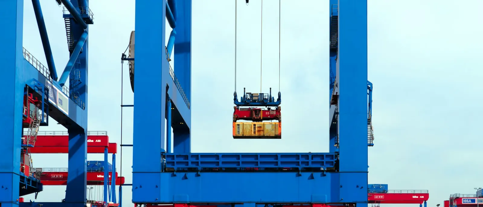 Ship-to-shore crane lifting a shipping container at a port terminal